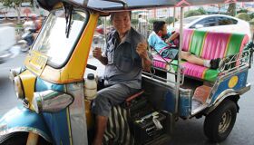 Tuk Tuk Driver on the Street in Bangkok, Thailand
